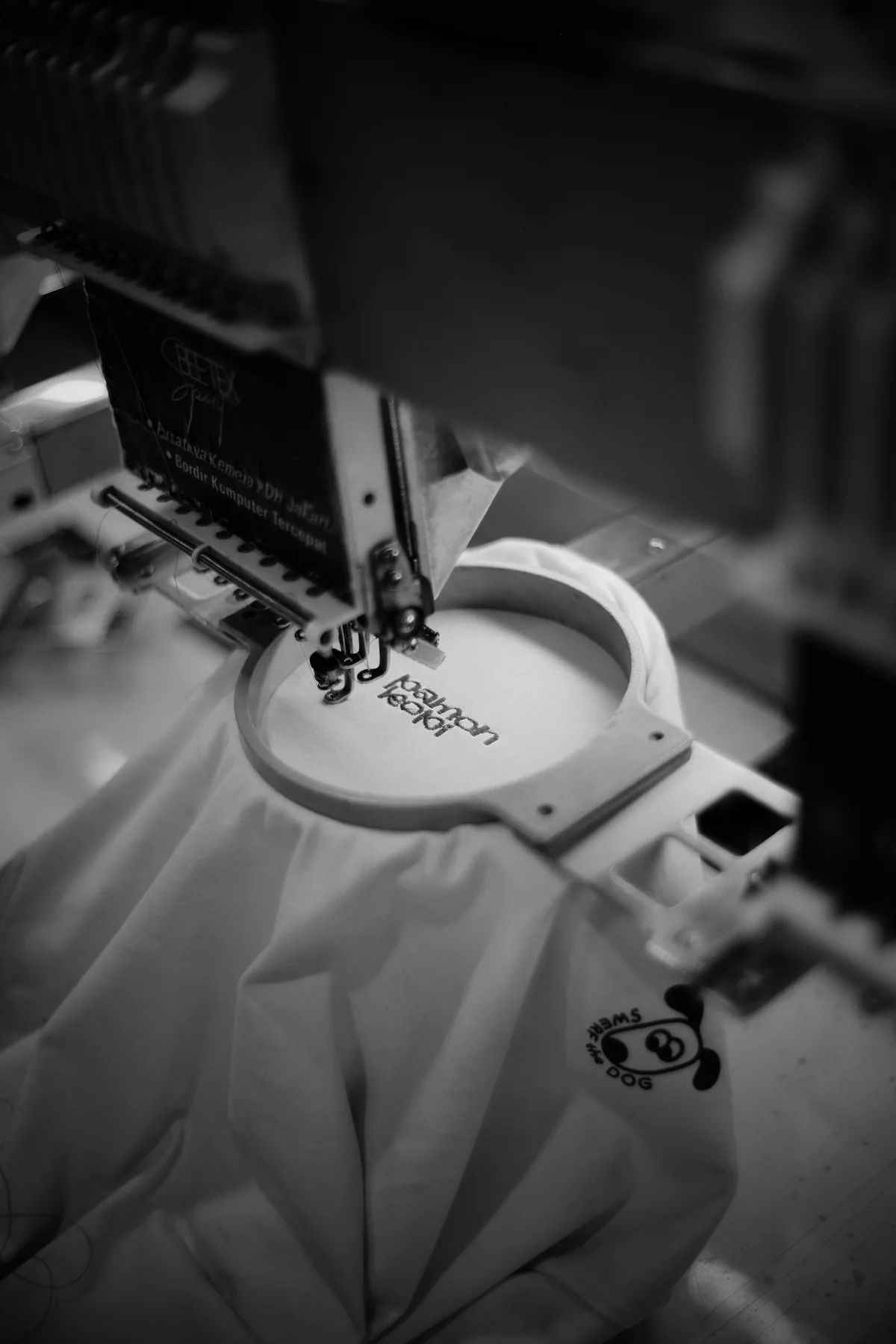 Embroidery machine stitching a design on fabric