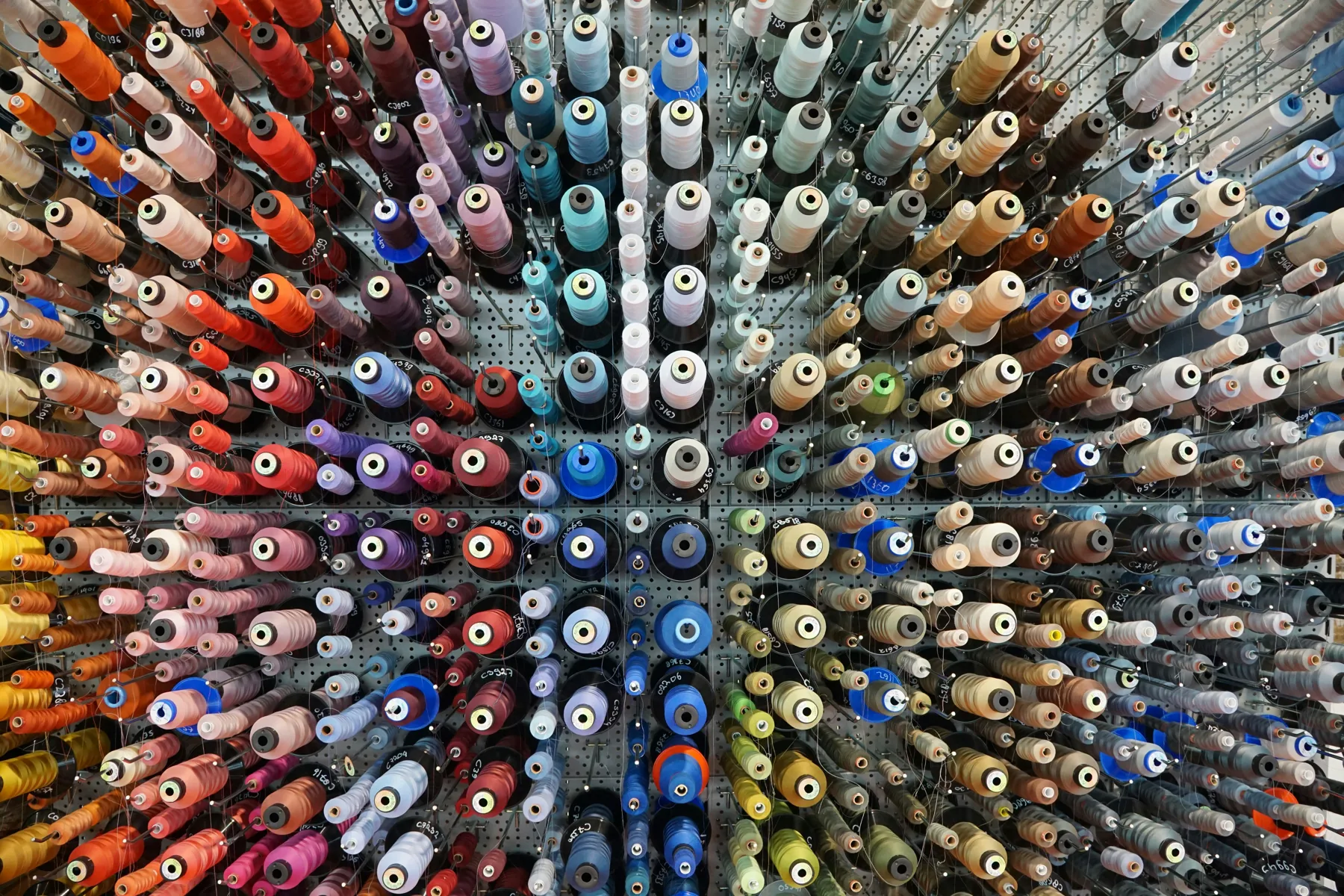 Large selection of colorful embroidery thread spools